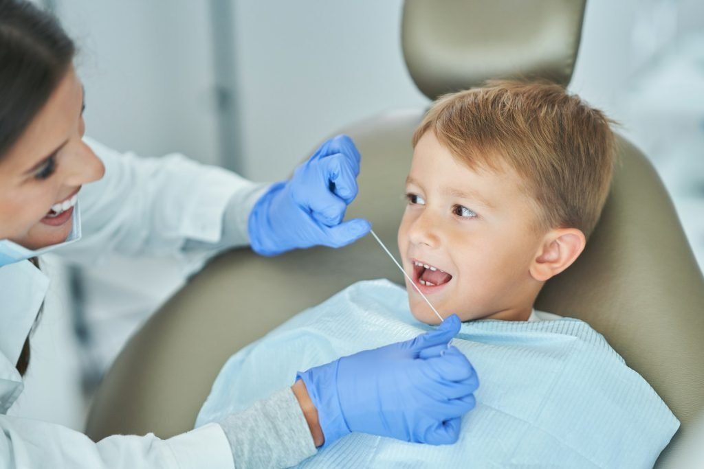 Little boy and female dentist in the dentists office